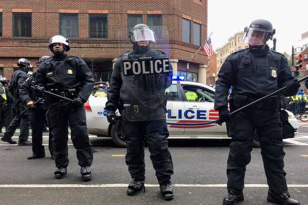 Washington DC police in riot gear brandishing clubs and other riot gear
