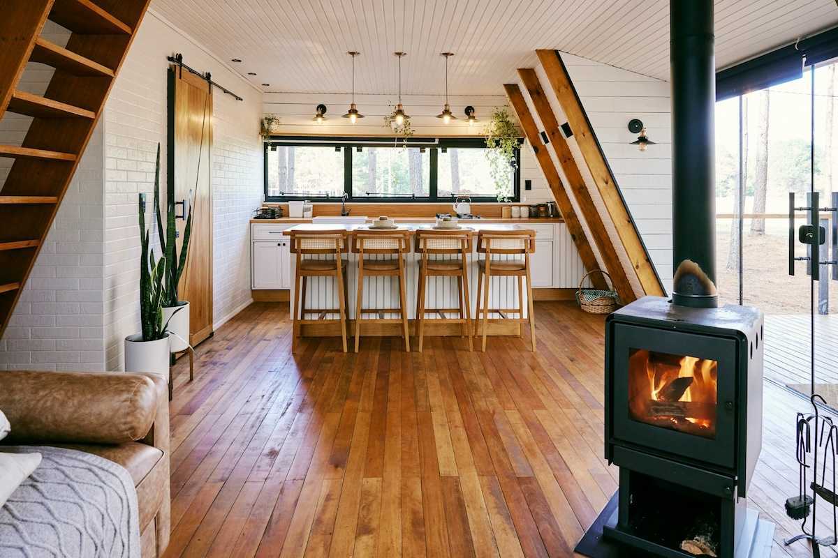 Well-lit home interior heated by wood-burning stove