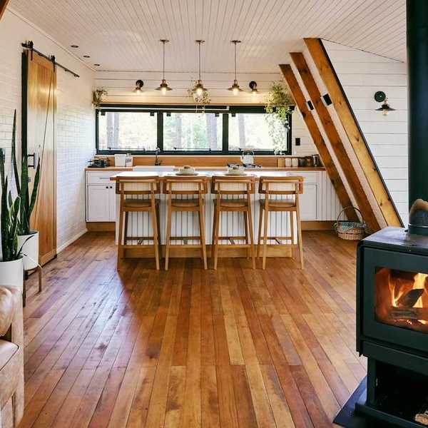 Well-lit home interior heated by wood-burning stove