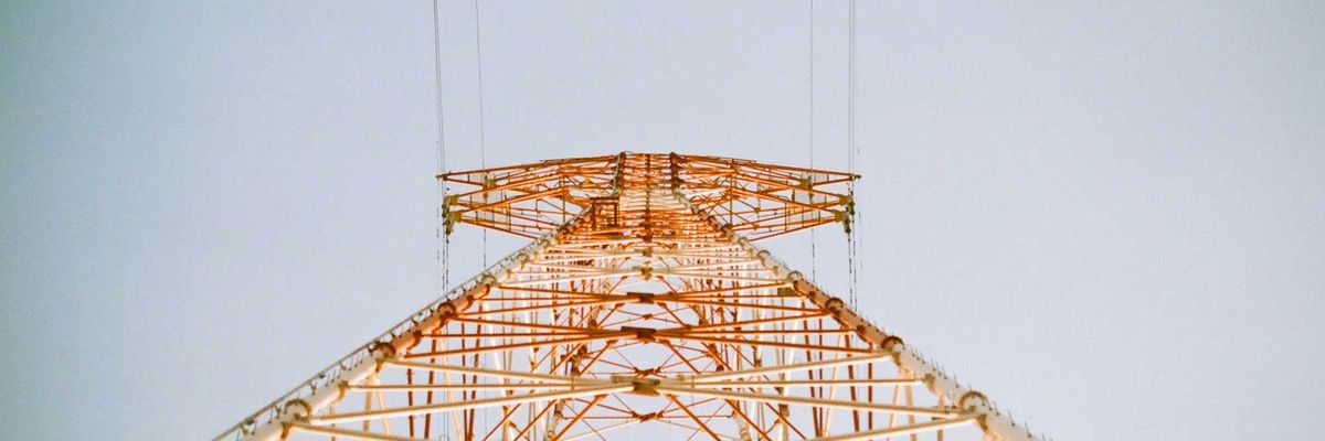 white and brown metal utility tower viewed from below