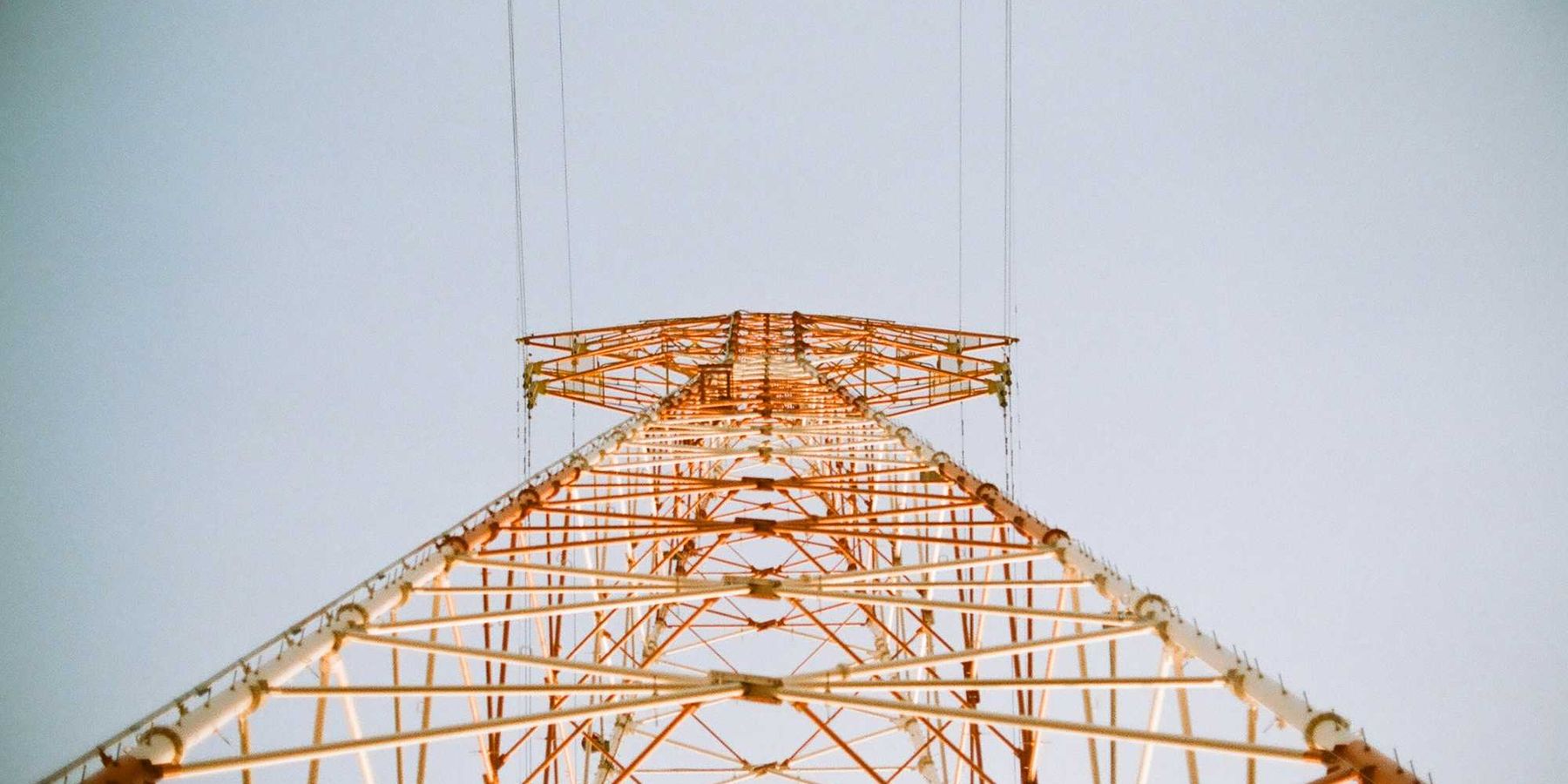 white and brown metal utility tower viewed from below