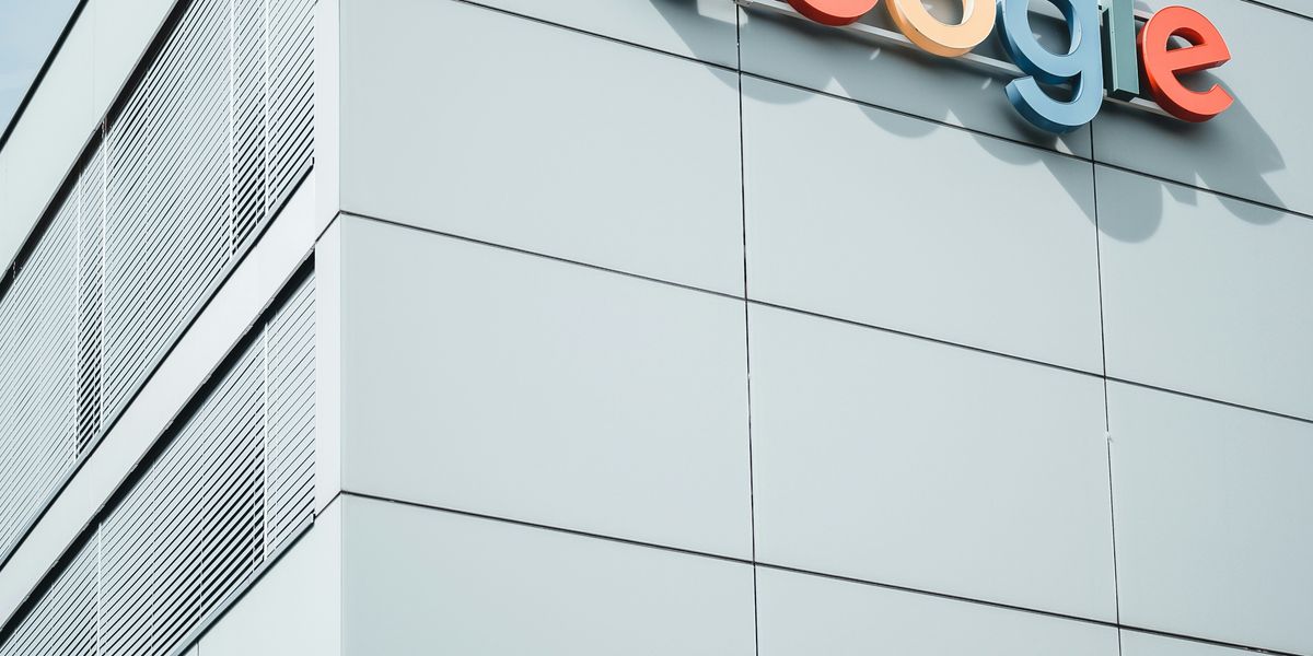 white concrete building during daytime with the Google logo on the side.