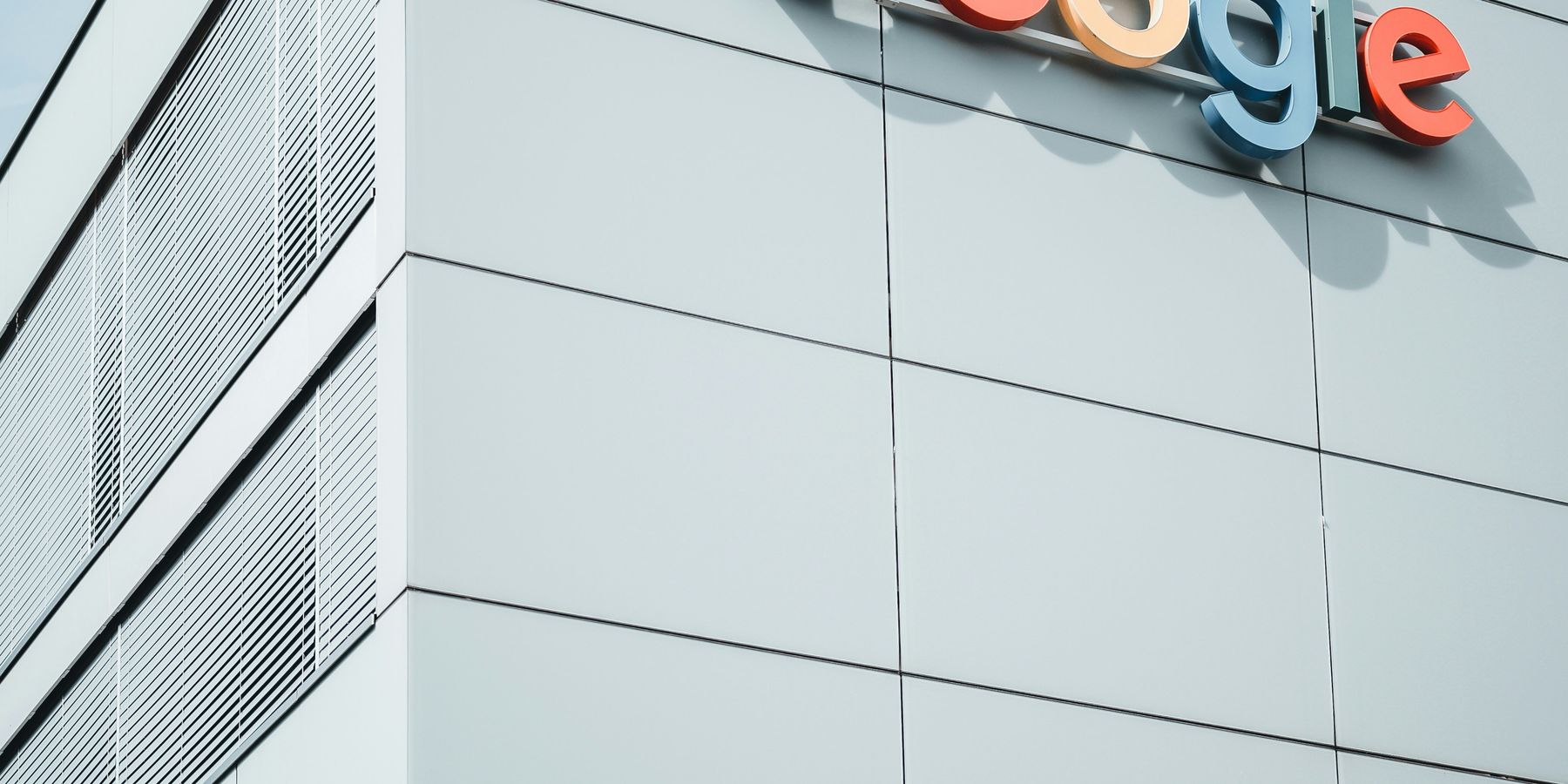 white concrete building during daytime with the Google logo on the side.