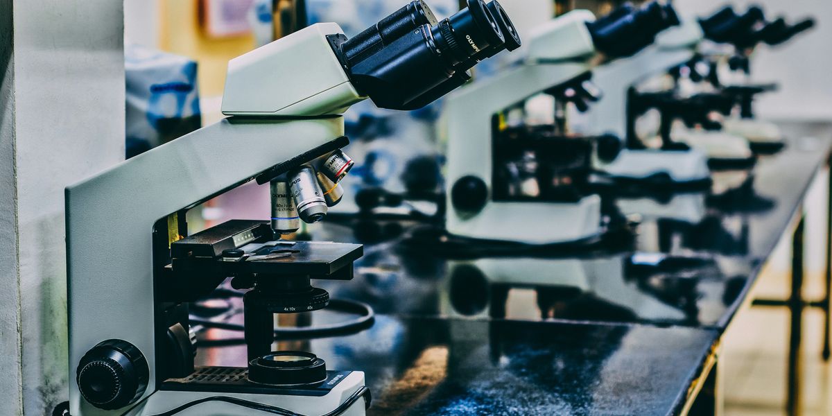 White microscopes on top of black table.