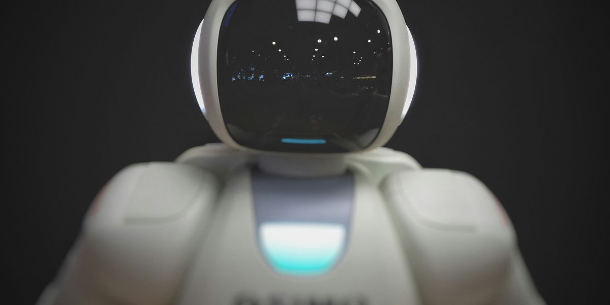 White robot figurine with a tinted black face shield helmet.