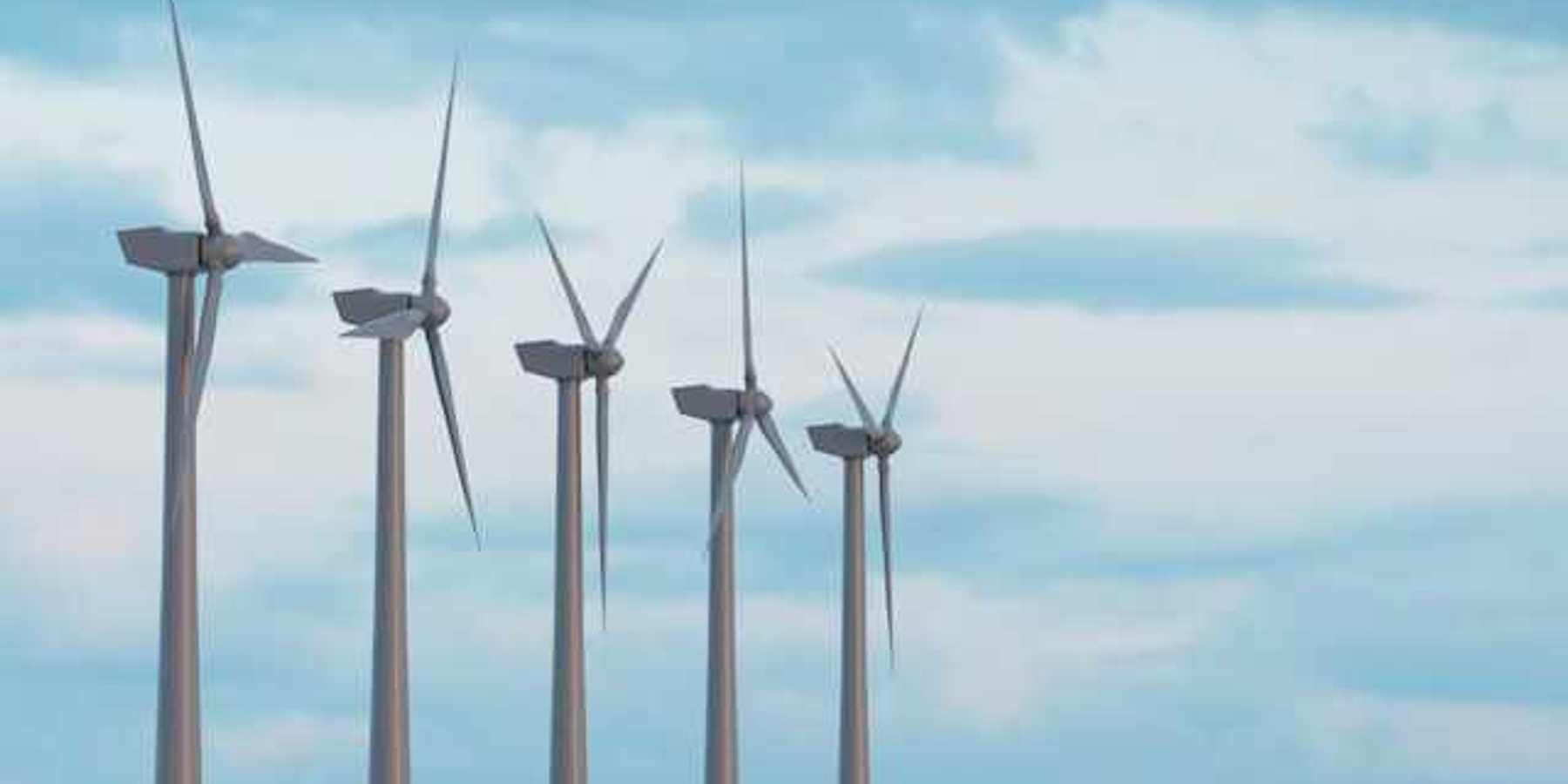 Wind turbines in a row against a blue sky