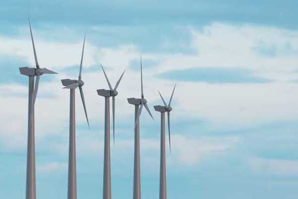 Wind turbines in a row against a blue sky