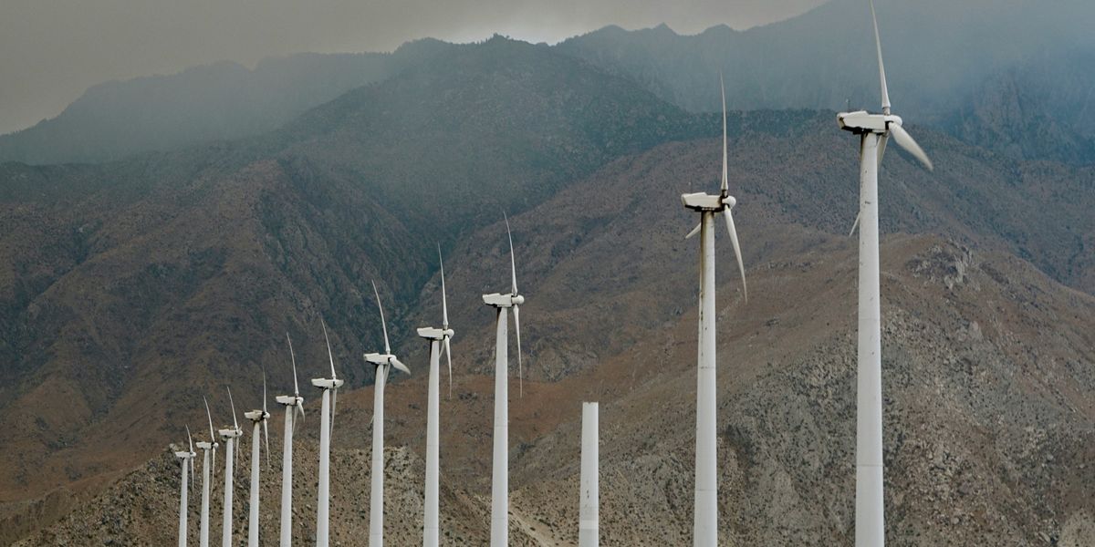 wind turbines with mountain backdrop