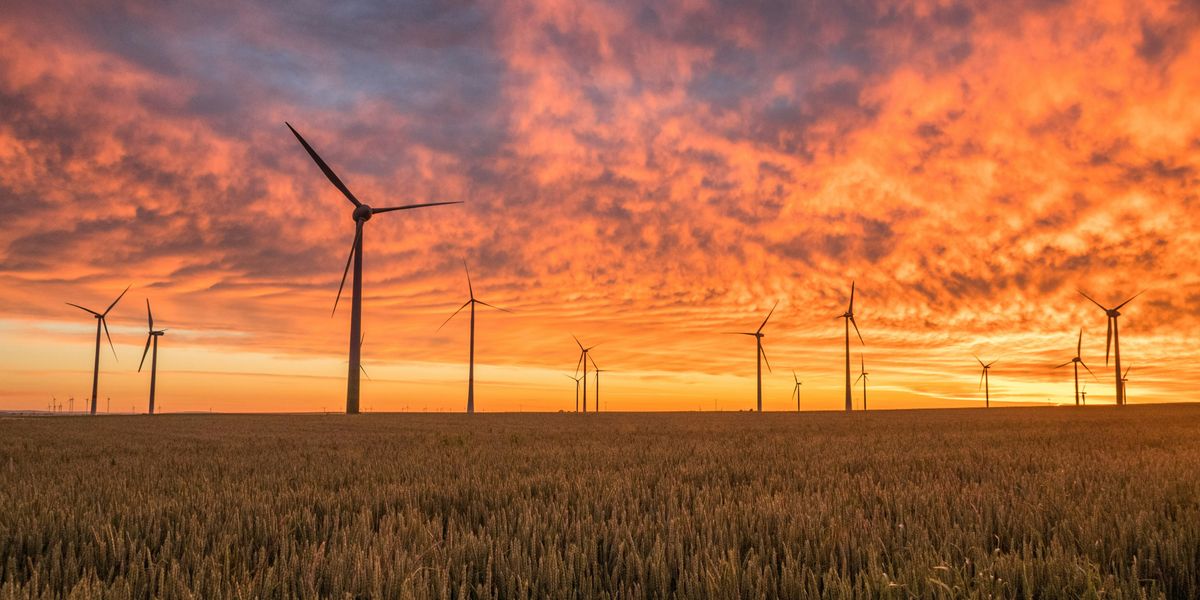 wind turbines with orange and pink sky