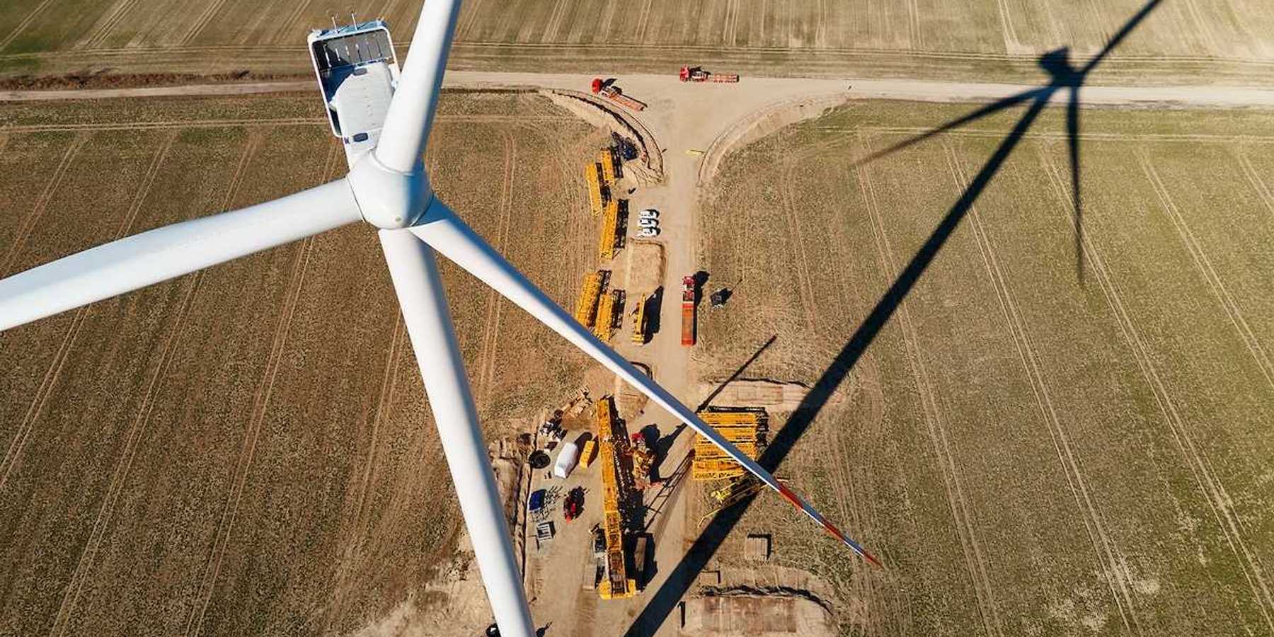 Windmill turbine maintenance at a construction site with cranes for assembling windmill tower,