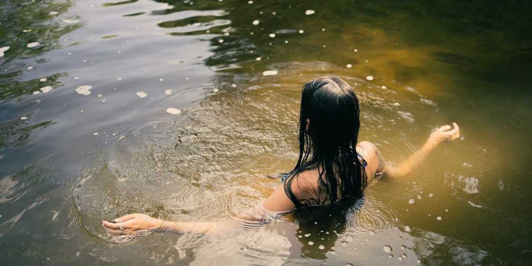Woman bathing in a river