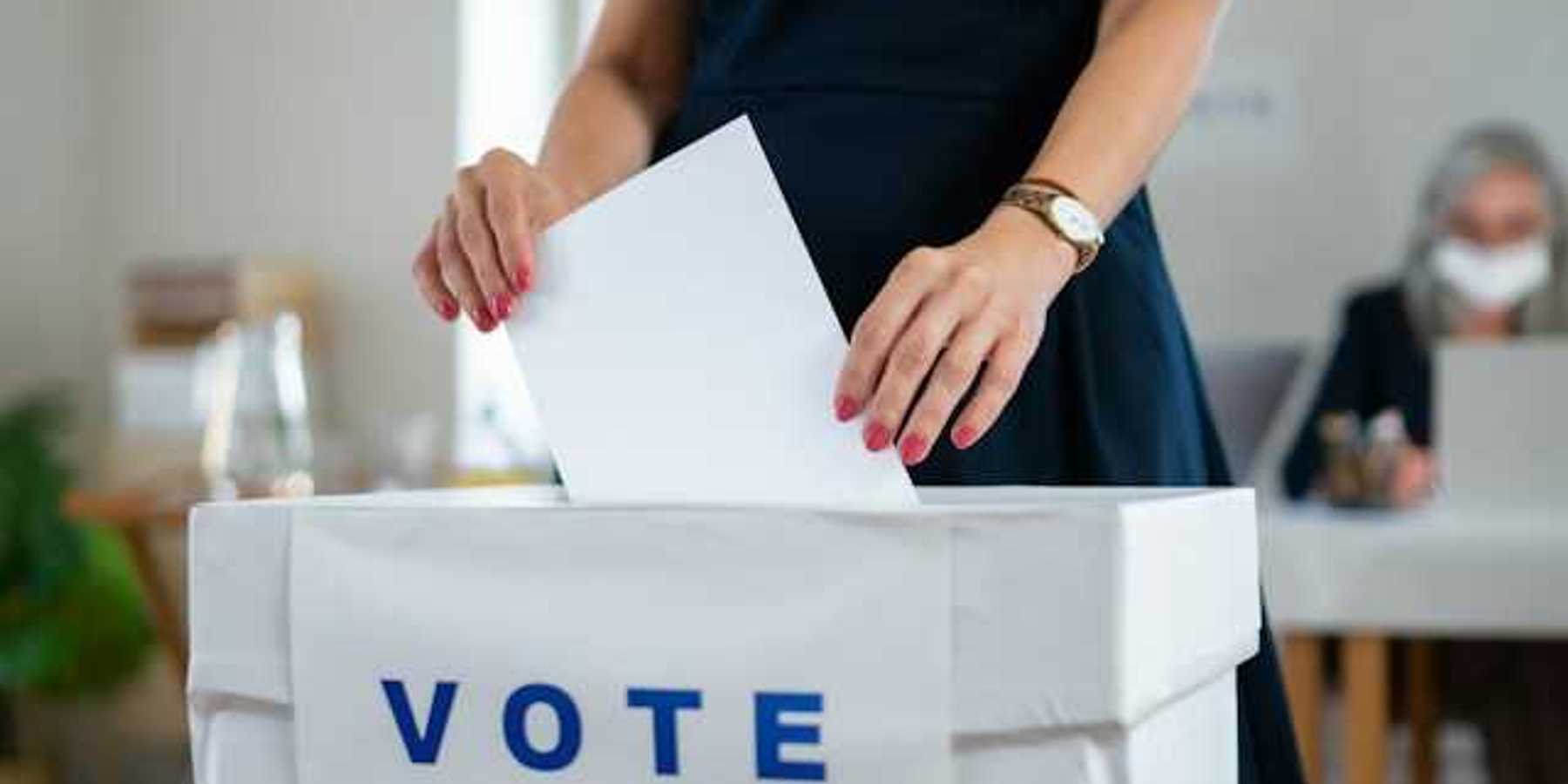 Woman putting her ballot in a voting box