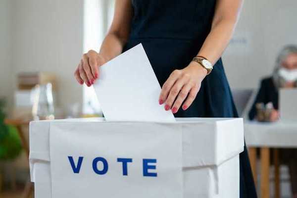 Woman putting her ballot in a voting box