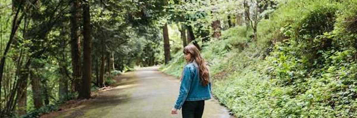 Woman walking on a forest path
