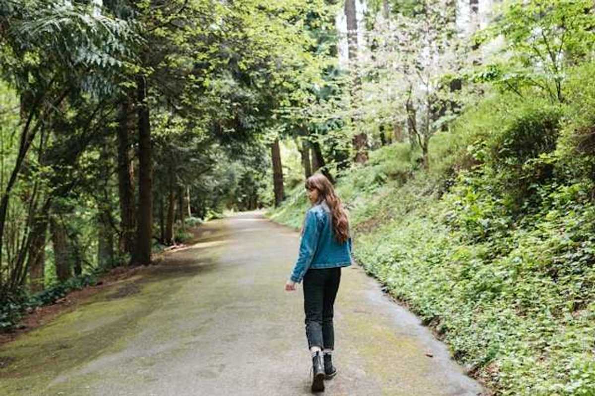 Woman walking on a forest path