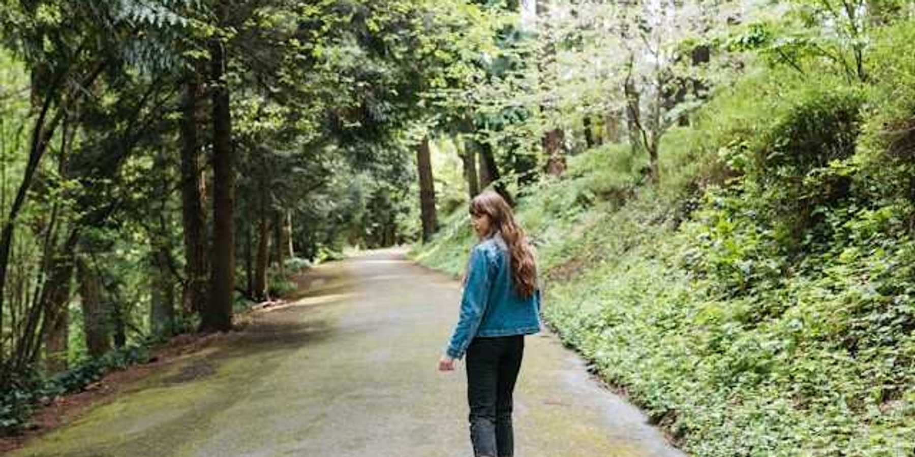 Woman walking on a forest path