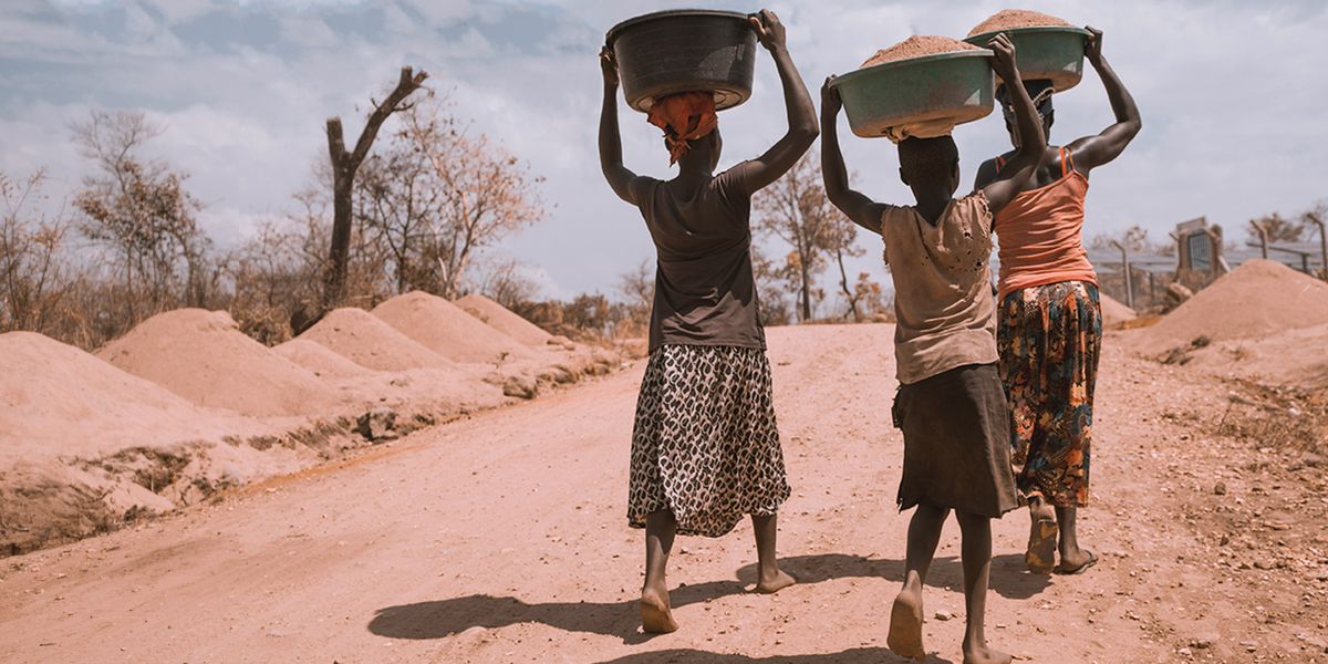 women hauling water on their heads