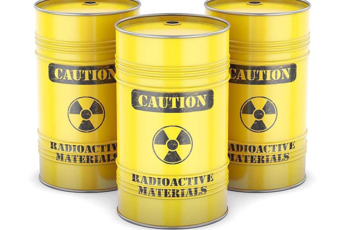 Yellow barrels labeled "CAUTION Radioactive Materials" in black letters