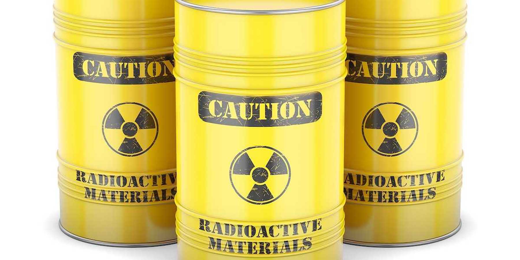 Yellow barrels labeled "CAUTION Radioactive Materials" in black letters