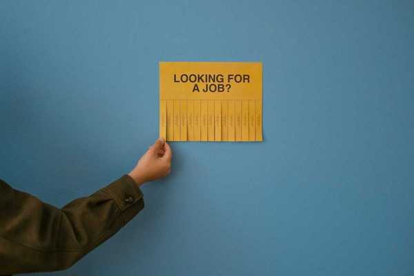 Yellow job posting "LOOKING FOR A JOB?" with tear-off phone number strips