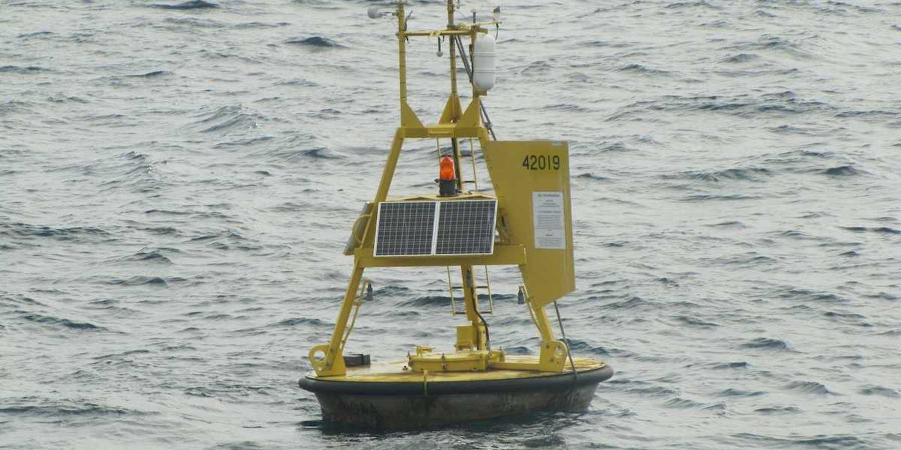 Yellow meteorological buoy floating in the western Gulf of Mexico