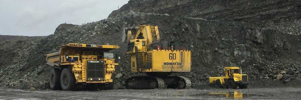 Yellow mining equipment parked in a coal mining cut