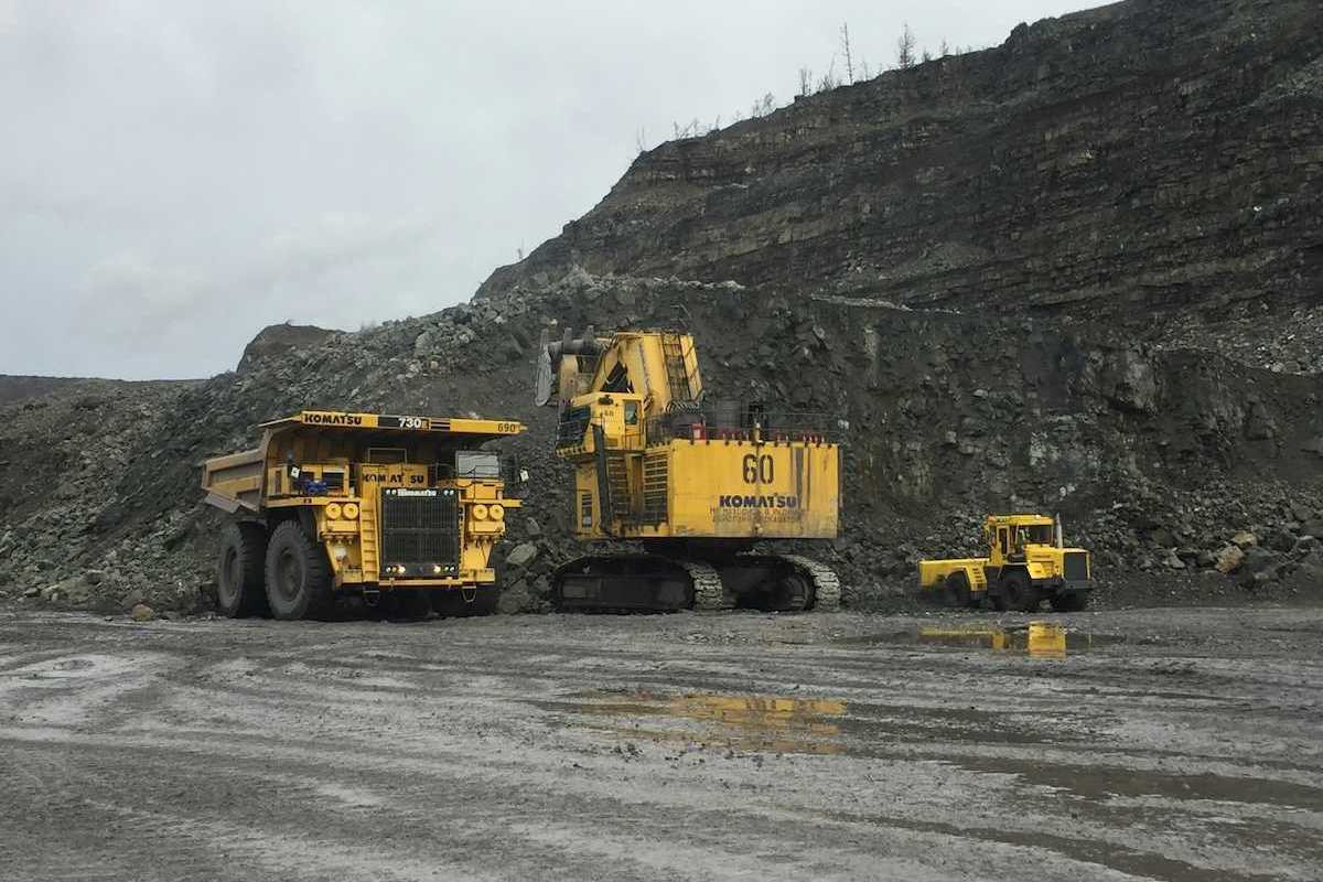 Yellow mining equipment parked in a coal mining cut