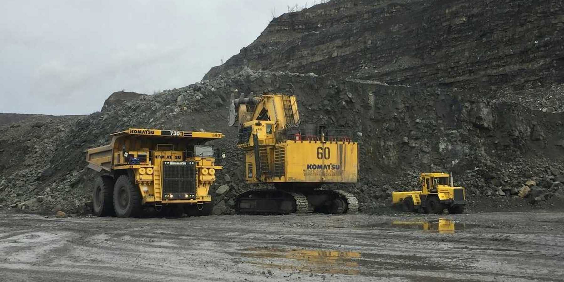 Yellow mining equipment parked in a coal mining cut