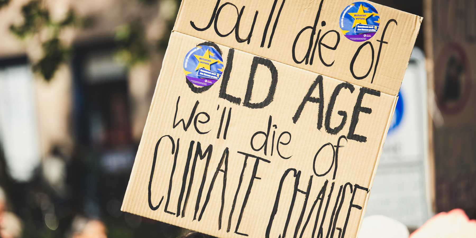 you'll die of old age we'll die of climate change text on protest sign.